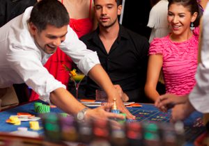 Man gathering chips at a roulette table